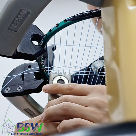 Certified stringer demonstrating advanced racquet stringing techniques for badminton and tennis