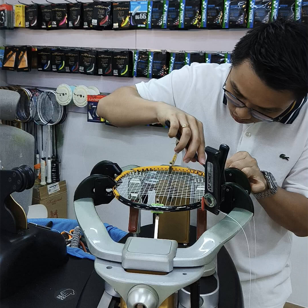 Jimmy Johanes Tjandra working with racquet stringing machine at BSW certification class Jimmy Johanes Tjandra working with racquet stringing machine at BSW certification class