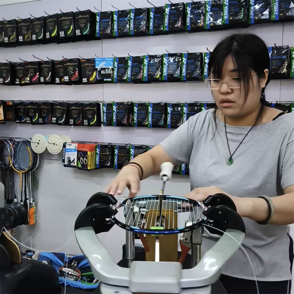 Elise Leong learning badminton stringing patterns during BSW training