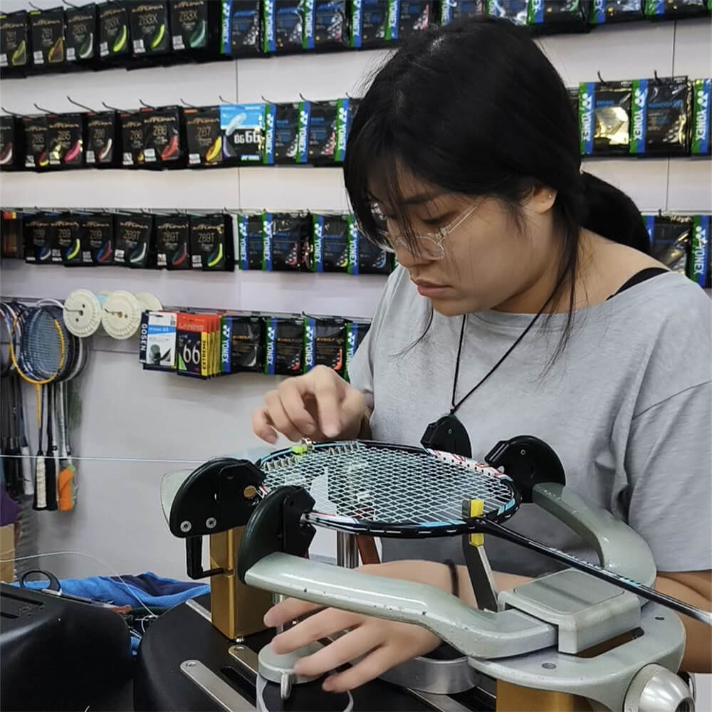 Elise Leong tying knots for racquet stringing at BSW badminton stringing course
