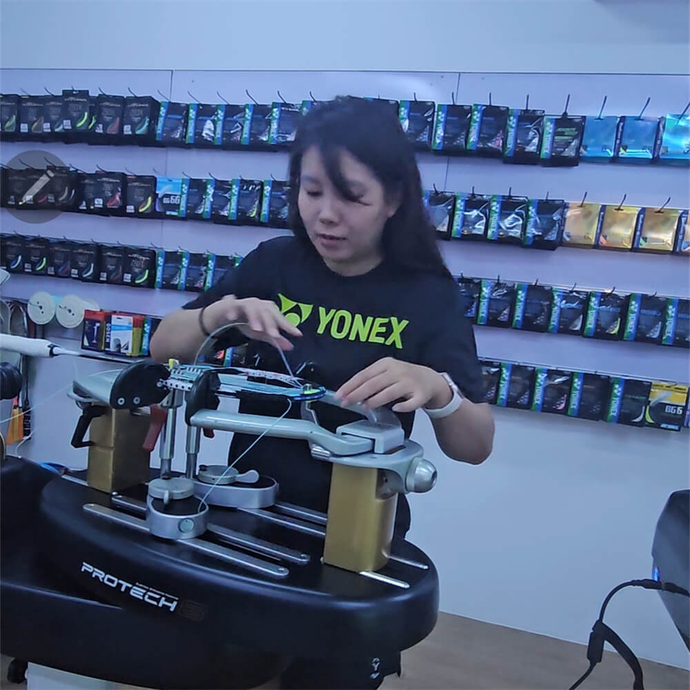 Lim Mei Wern using electronic stringing machine during BSW professional stringer workshop Singapore