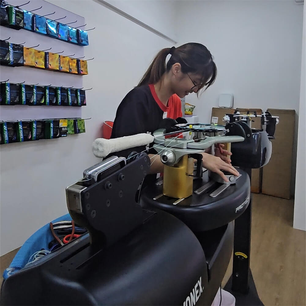 Ngan Xien Hwee using electronic stringing machine during BSW professional stringer workshop Ngan Xien Hwee using electronic stringing machine during BSW professional stringer workshop