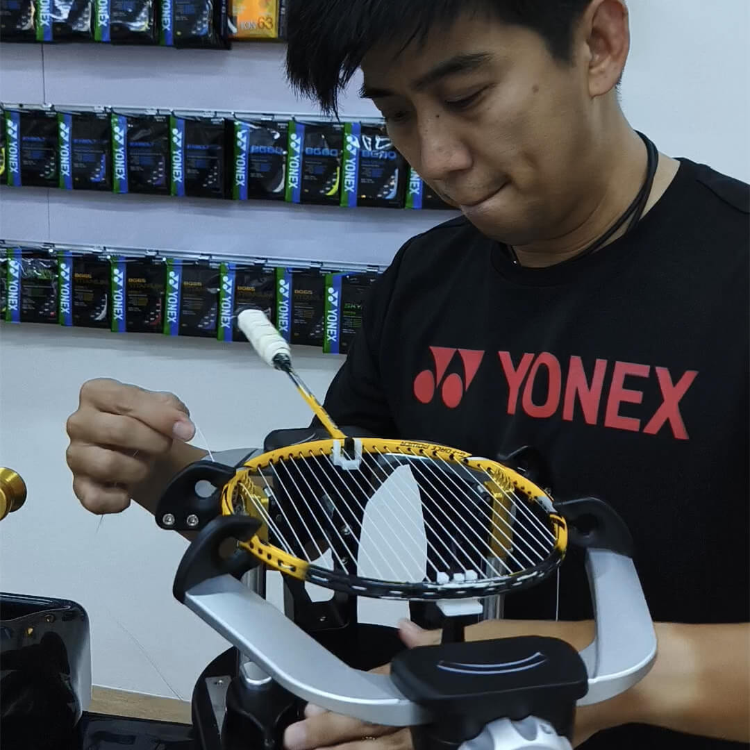 Raymond Tan learning badminton stringing patterns during BSW training Raymond Tan learning badminton stringing patterns during BSW training