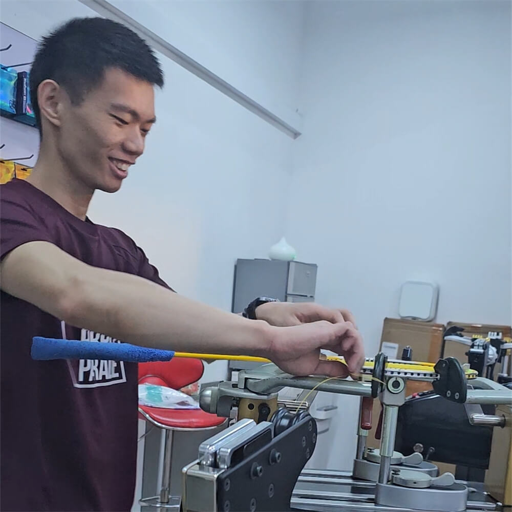Roger Lin studying badminton stringing theory at BSW class
