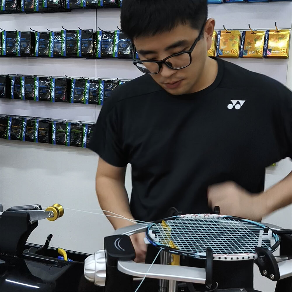 Wincent Chuah learning badminton stringing patterns during BSW training